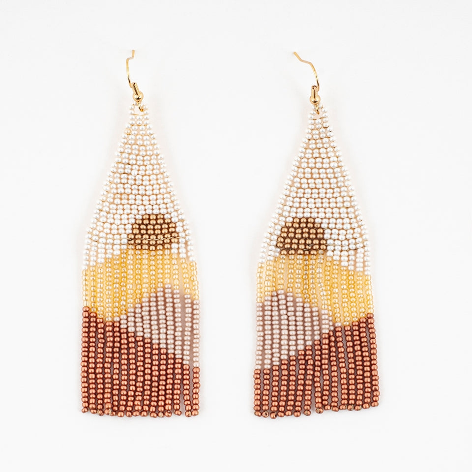 beaded earrings with a cream triangle top, a bronze half circle design within the beads then fringe in layers of gold, mauve and bronze.