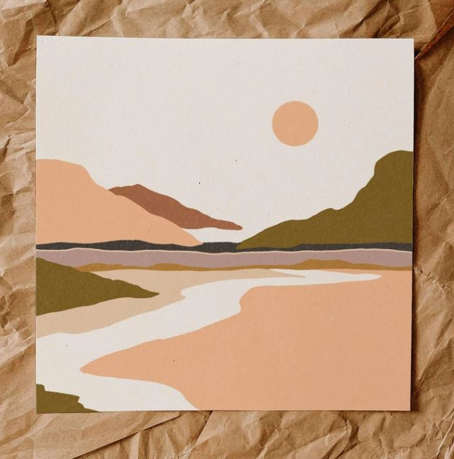A painterly print of a day time desertscape, features mountains and a peach sun. In foreground is a white path leading back to the mountains. Colors are moss, peach, tan, mauve and clay.