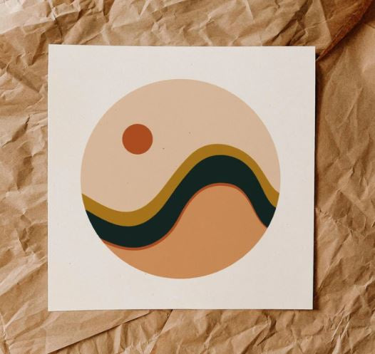 Abstract wave print has a circle design with a peachy clay color on bottom, black and mustard waves in the middle and at the top a pale sky with an orange sun in the top left.