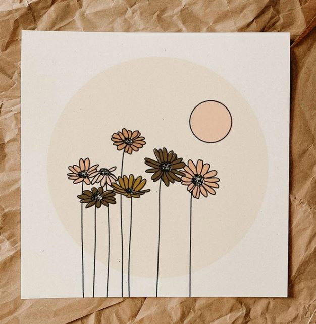 Art print featuring daisies in pink and taupe colors in a pake pink circle, with peach sun above that, and white background