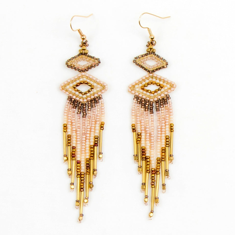 Beaded earrings with a small beaded wide diamond shape at top, a medium diamond shape below and danging beaded fringe below that. Colors: gold, bronze and cream. Earrings have hooks.