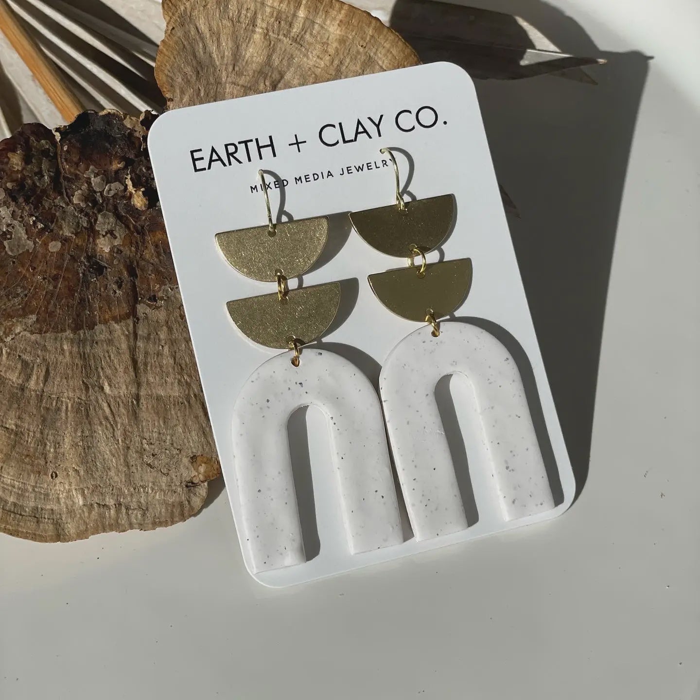 The Peppered White Double Arch Earrings by Earth + Clay Collective